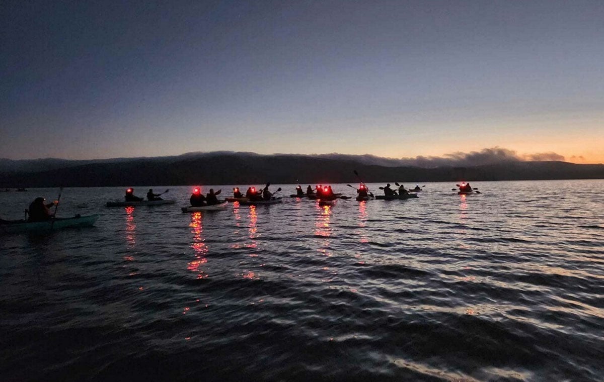 A group of kayakers set out at dusk seeking bioluminescence in Tomales Bay